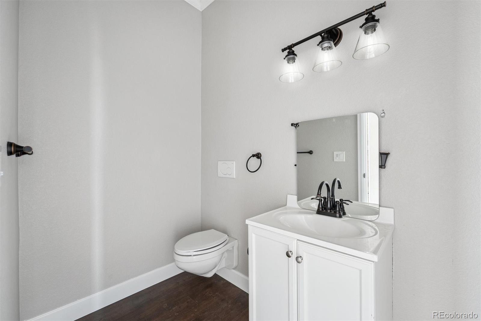 2105 Timberlake Road Byers, CO 80103 - Photo 12 of 48 a bathroom with a sink toilet and vanity