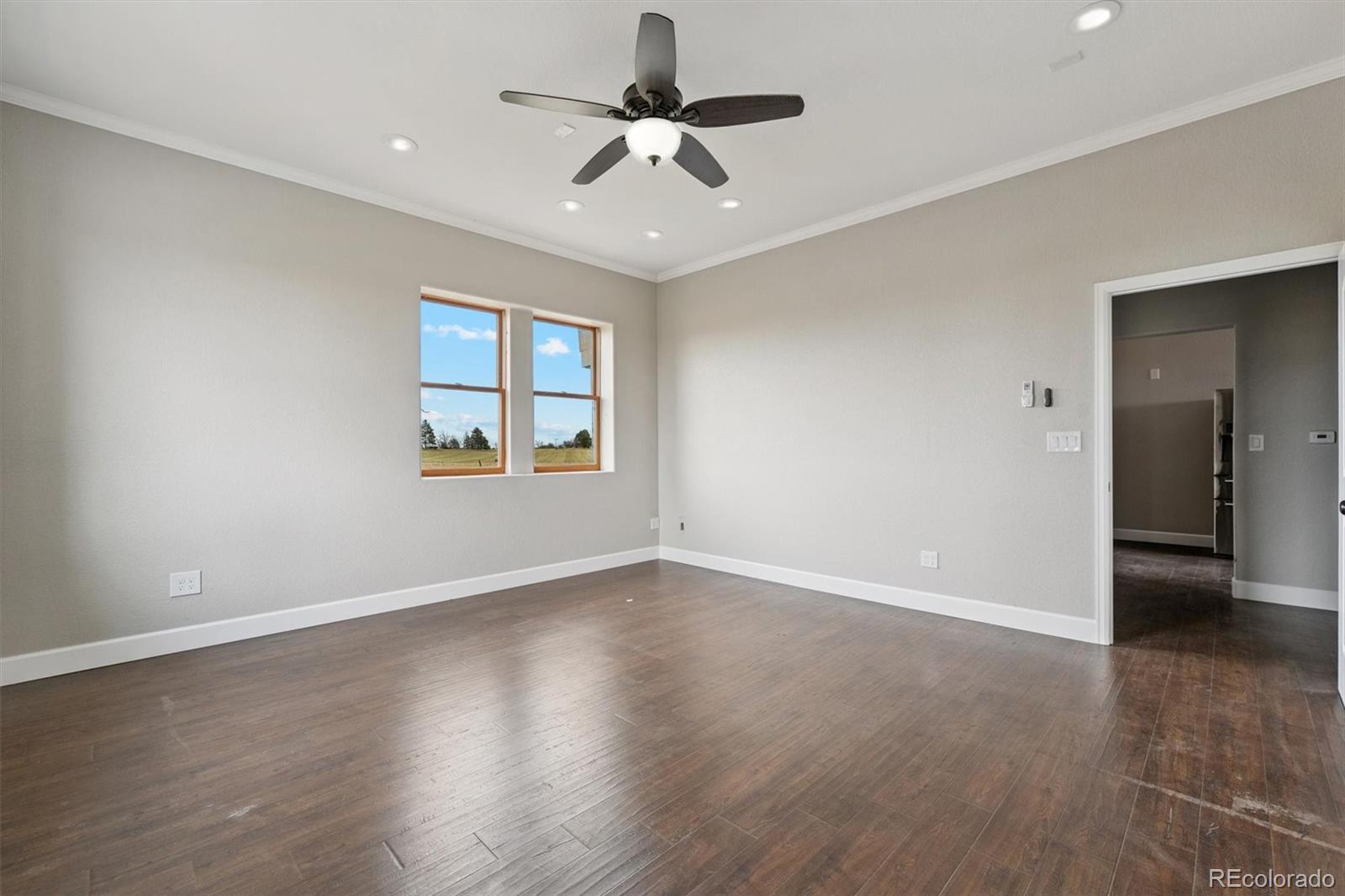 2105 Timberlake Road Byers, CO 80103 - Photo 17 of 48 wooden floor in an empty room with a window