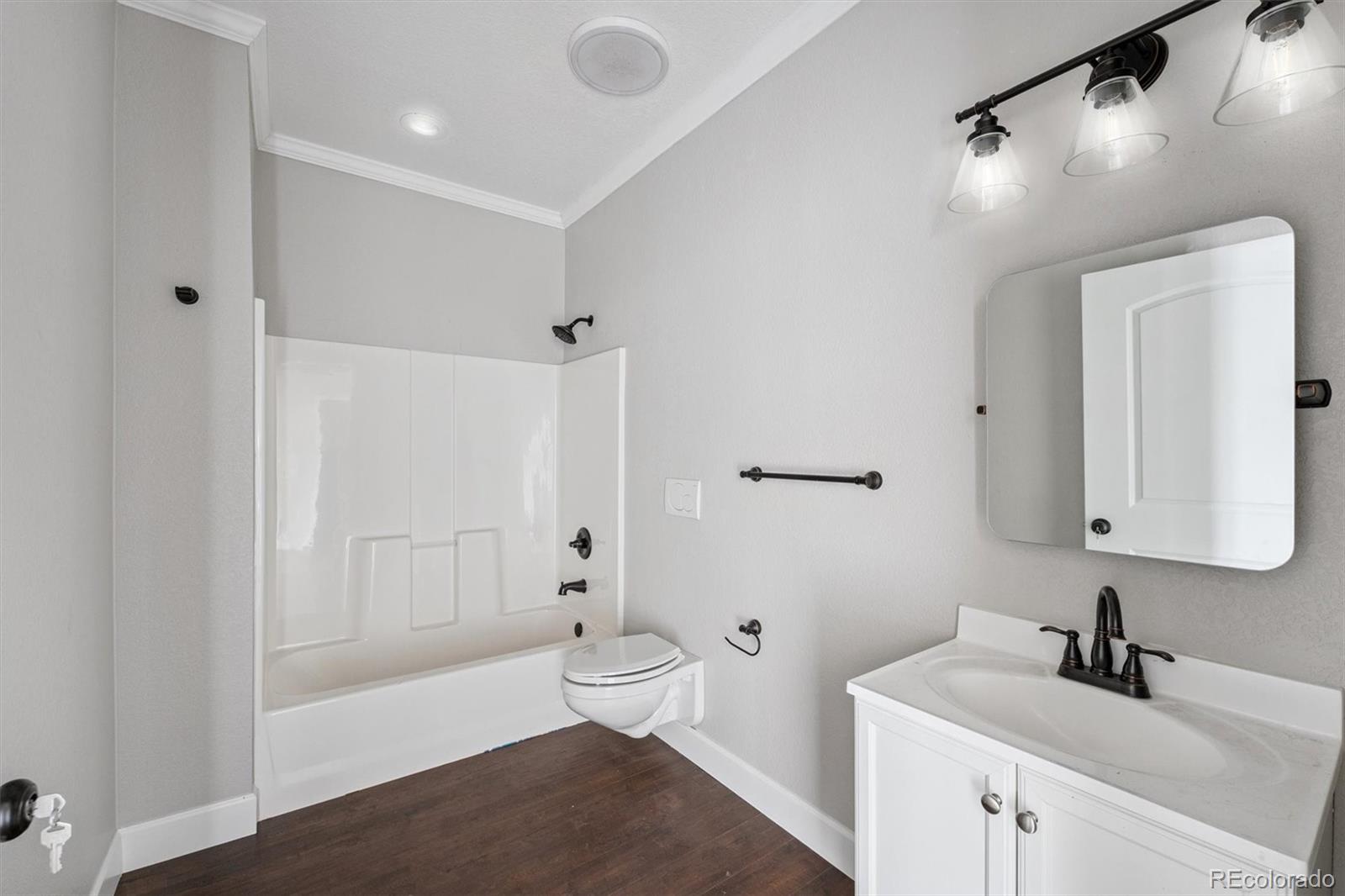 2105 Timberlake Road Byers, CO 80103 - Photo 18 of 48 a bathroom with a sink a toilet and shower