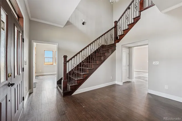 a view of staircase with wooden floor and a chandelier
