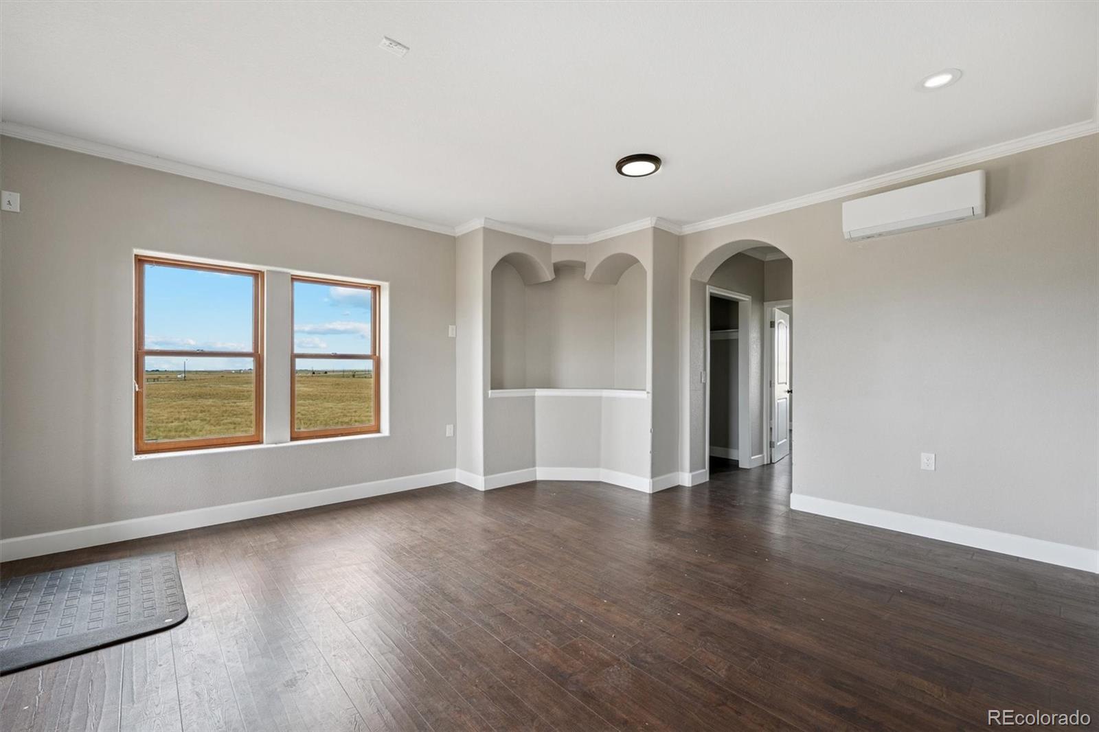 2105 Timberlake Road Byers, CO 80103 - Photo 20 of 48 a view of an empty room with wooden floor and a window