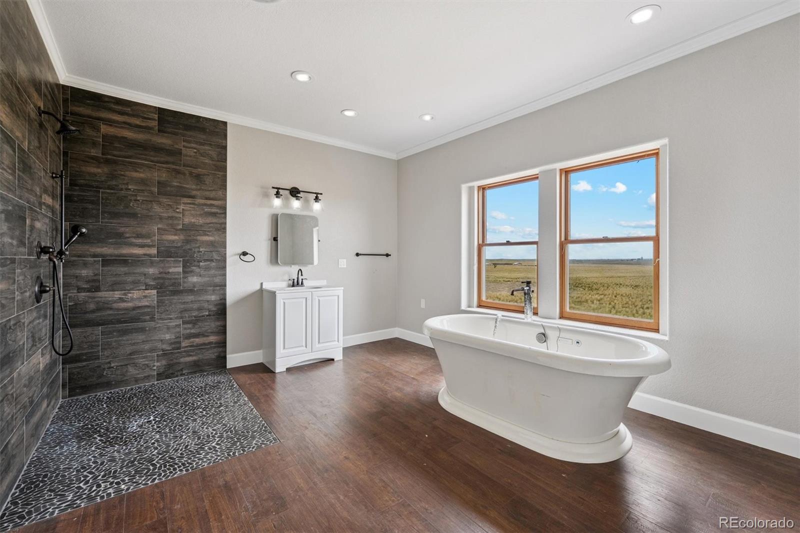 2105 Timberlake Road Byers, CO 80103 - Photo 22 of 48 a view of an empty room with wooden floor and a window