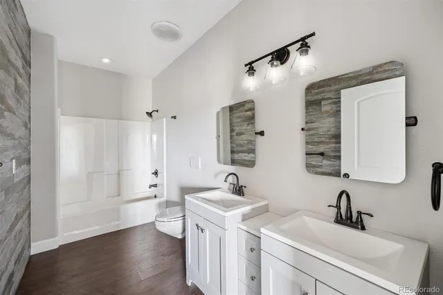 a bathroom with a double vanity sink mirror and shower