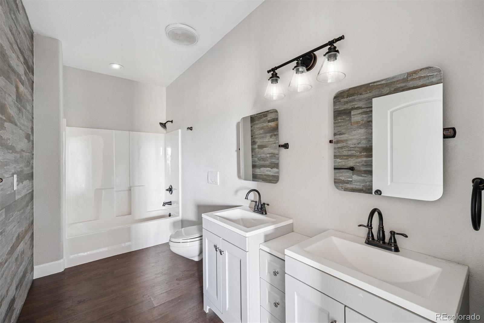 2105 Timberlake Road Byers, CO 80103 - Photo 24 of 48 a bathroom with a double vanity sink mirror and shower