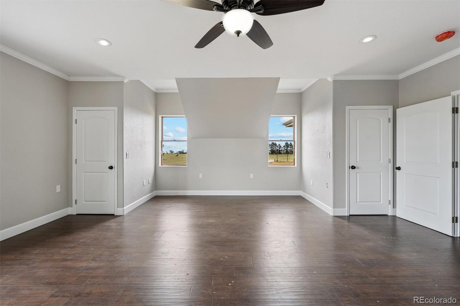 2105 Timberlake Road Byers, CO 80103 - Photo 30 of 48 a view of an empty room with wooden floor and a window