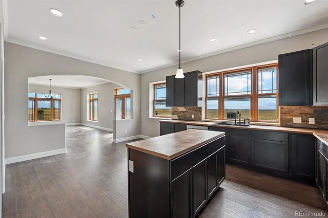 a kitchen with stainless steel appliances granite countertop a stove and a sink