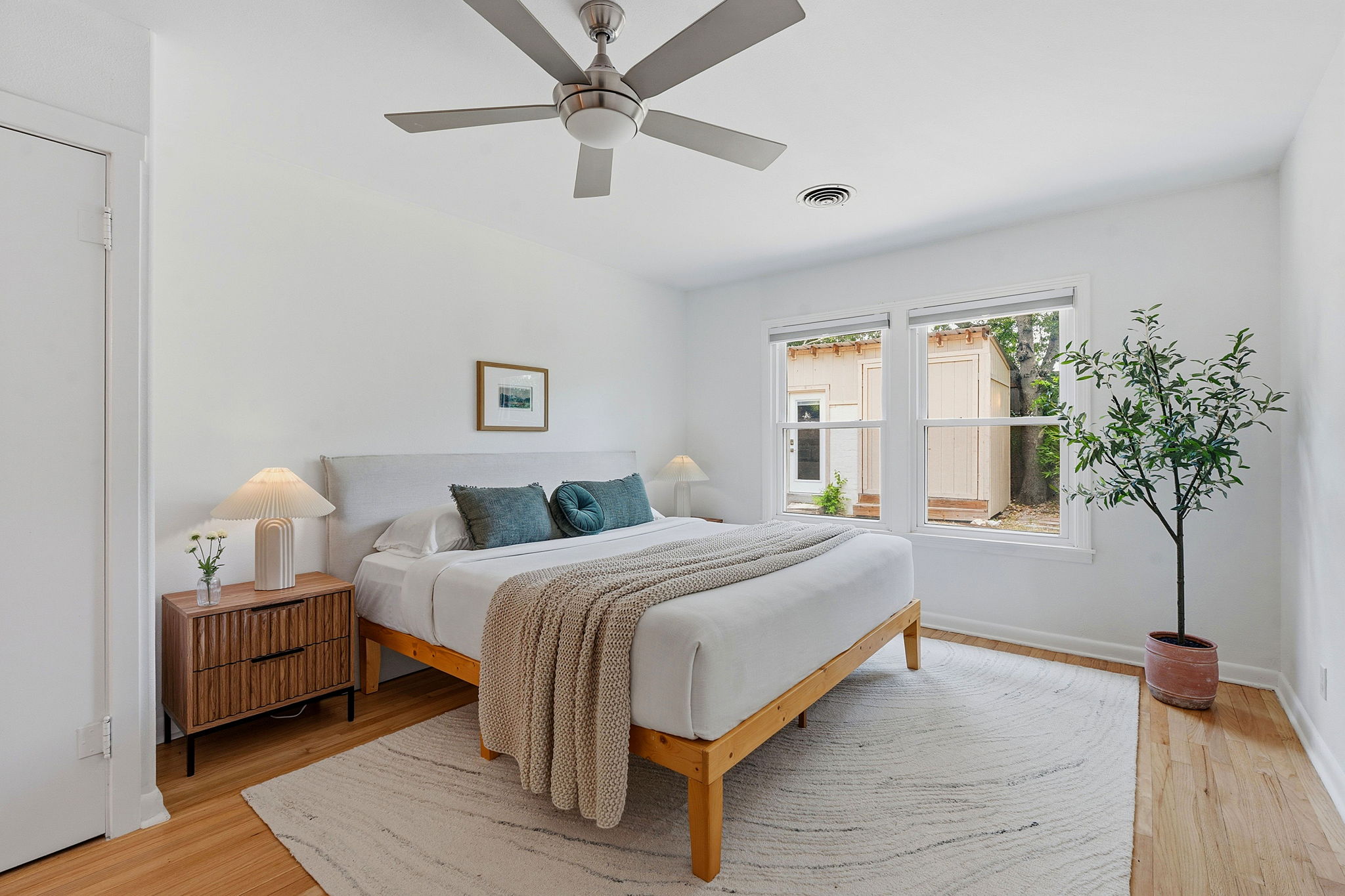 900 Stark Street Austin, TX 78756 - Photo 12 of 25 Hardwood floors and bright windows illuminate this comfortable, well-lit primary bedroom.