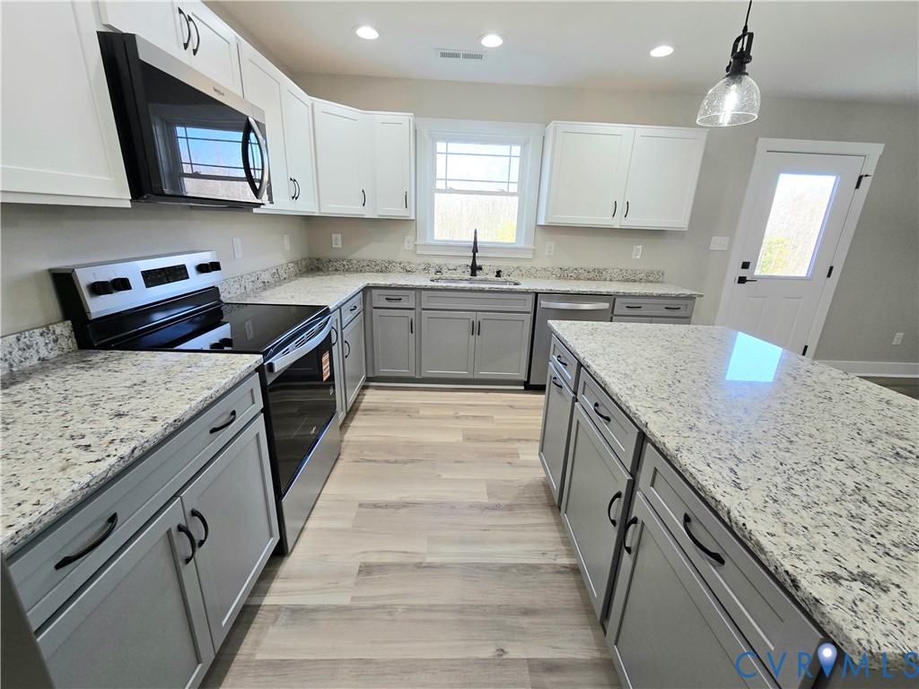 1781 Bumpass Road Bumpass, VA 23024 - Photo 13 of 26 a kitchen with granite countertop a sink stove and cabinets