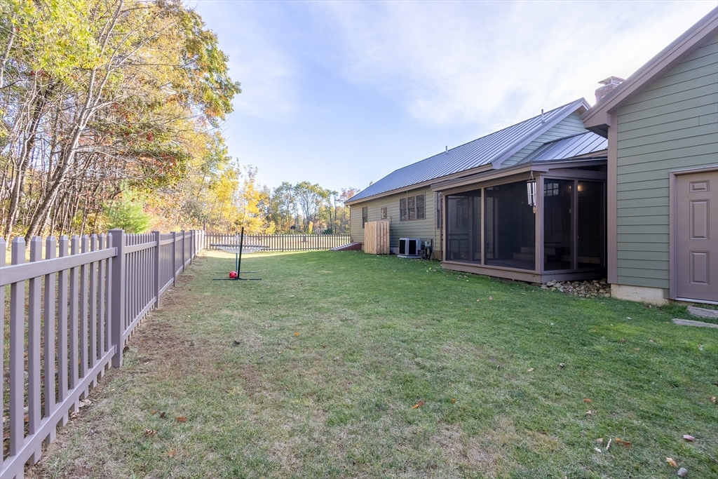 216 Padre Road New Braintree, MA 01531 - Photo 27 of 29 a view of a house with a yard and wooden fence