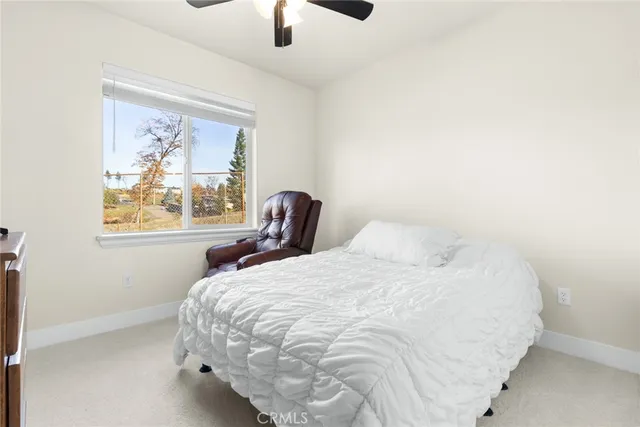 a bedroom with a bed and a painting on the wall