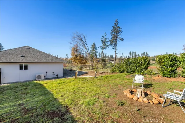 a backyard of a house with table and chairs