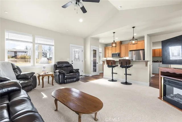 a living room with furniture and a chandelier
