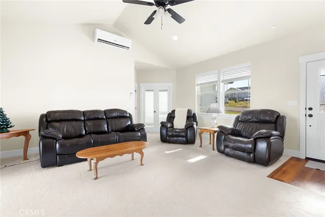 a living room with furniture and a ceiling fan