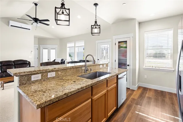 a kitchen with sink stove and refrigerator