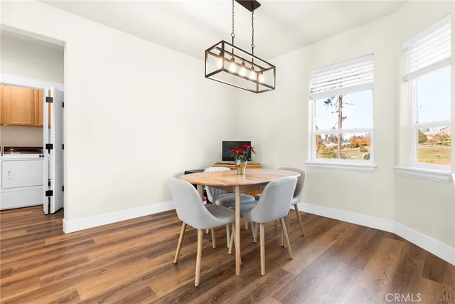 a view of a dining room with furniture window and wooden floor