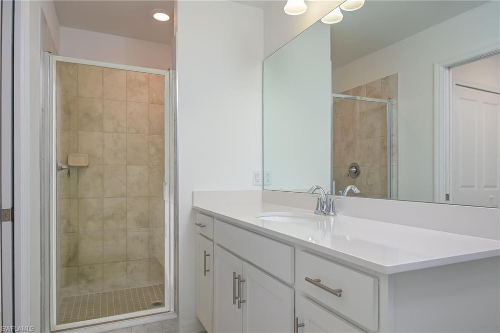 5835 Double Eagle Circle, Unit 4724 Immokalee, FL 34142 - Photo 13 of 25 a bathroom with a sink and a mirror