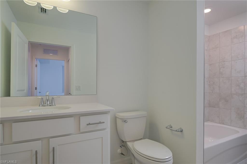 5835 Double Eagle Circle, Unit 4724 Immokalee, FL 34142 - Photo 17 of 25 a bathroom with a sink toilet vanity and bathtub