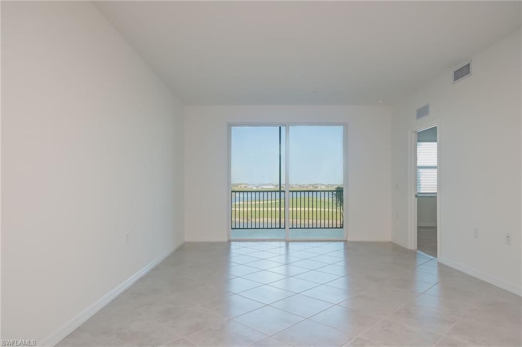 5835 Double Eagle Circle, Unit 4724 Immokalee, FL 34142 - Photo 3 of 25 a view of an empty room with a window