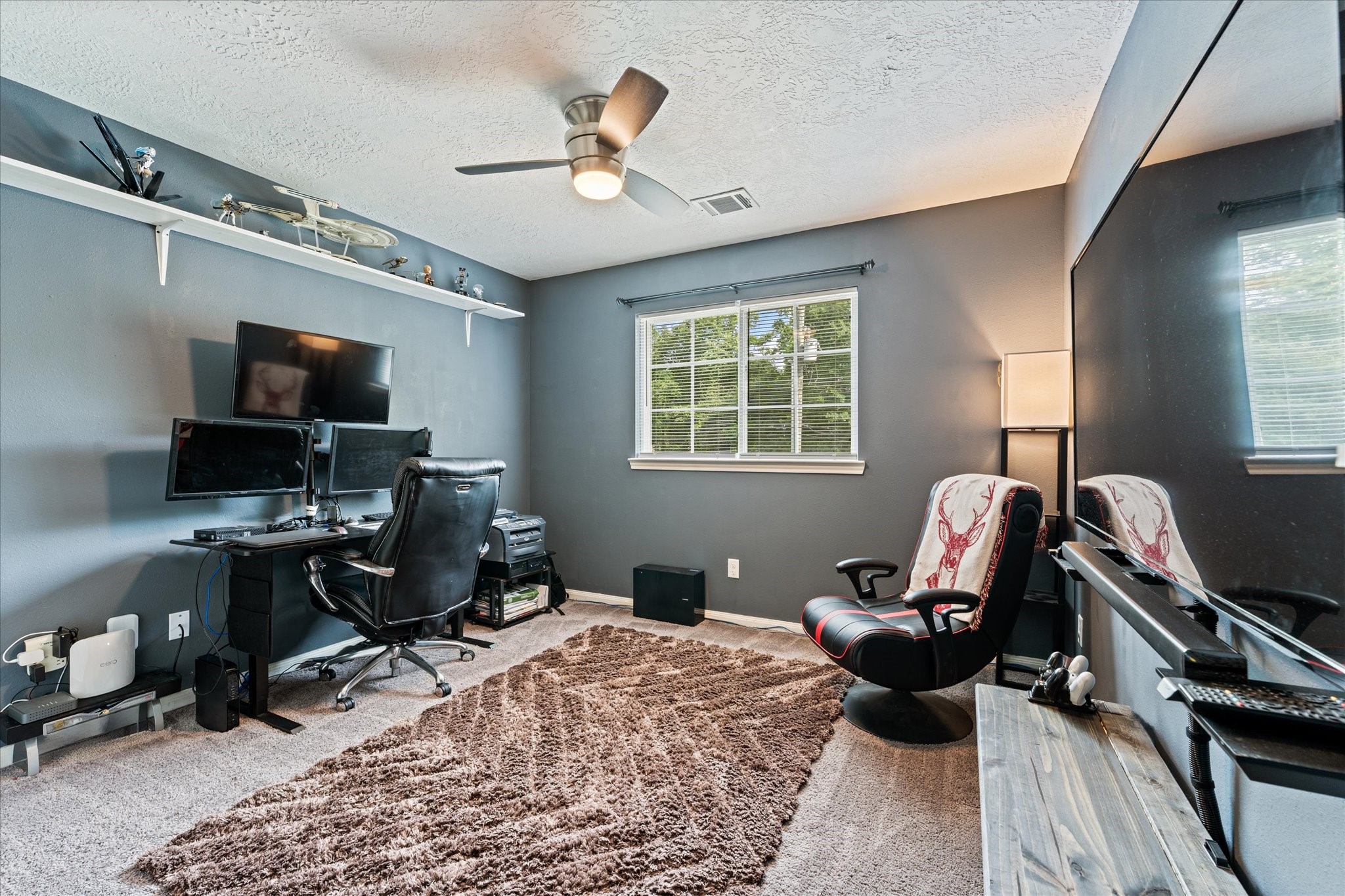 3998 Frontier Road Willis, TX 77378 - Photo 25 of 33 a living room with furniture a rug and a window