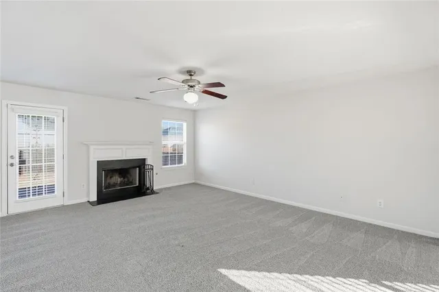 a view of an empty room with a fireplace