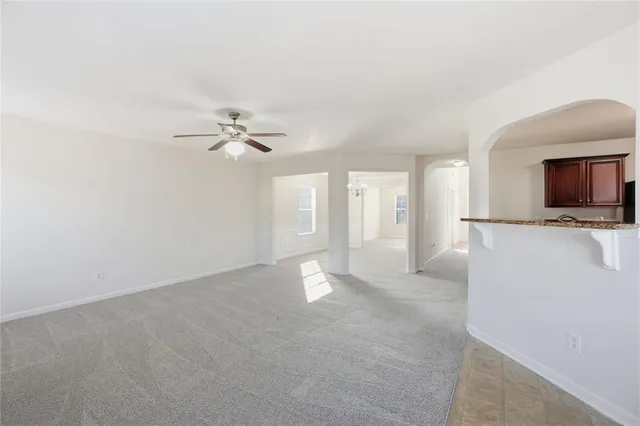a view of a livingroom with a ceiling fan and a flat screen tv