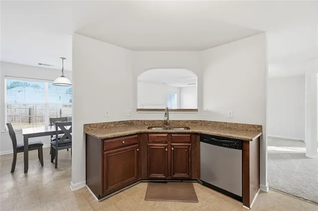 a kitchen with a sink and a stove top oven