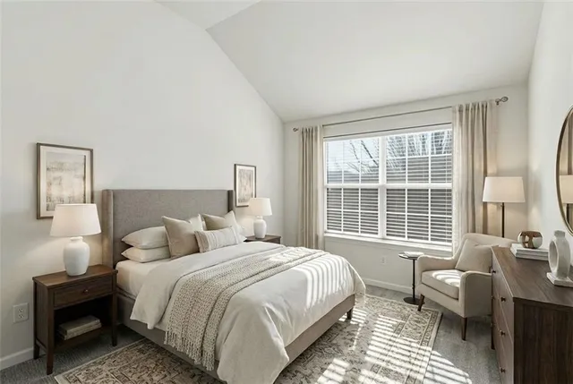 a bedroom with a bed and a large window