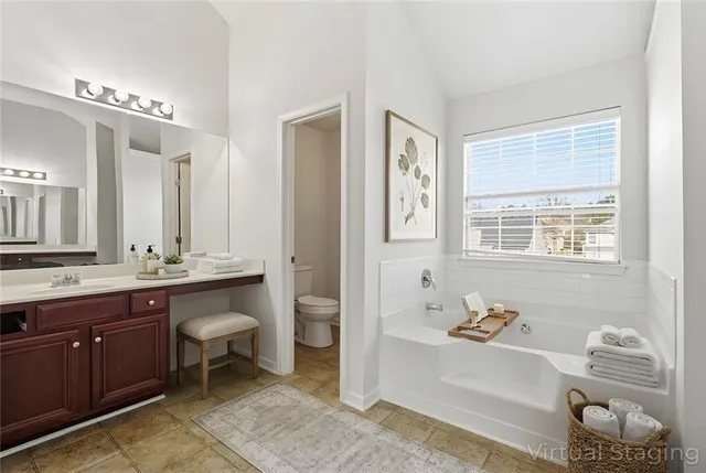 a spacious bathroom with a tub sink shower and mirror