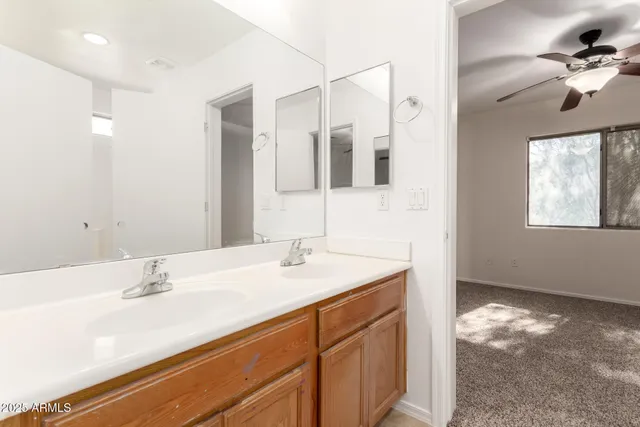 an empty room with a window and a fan