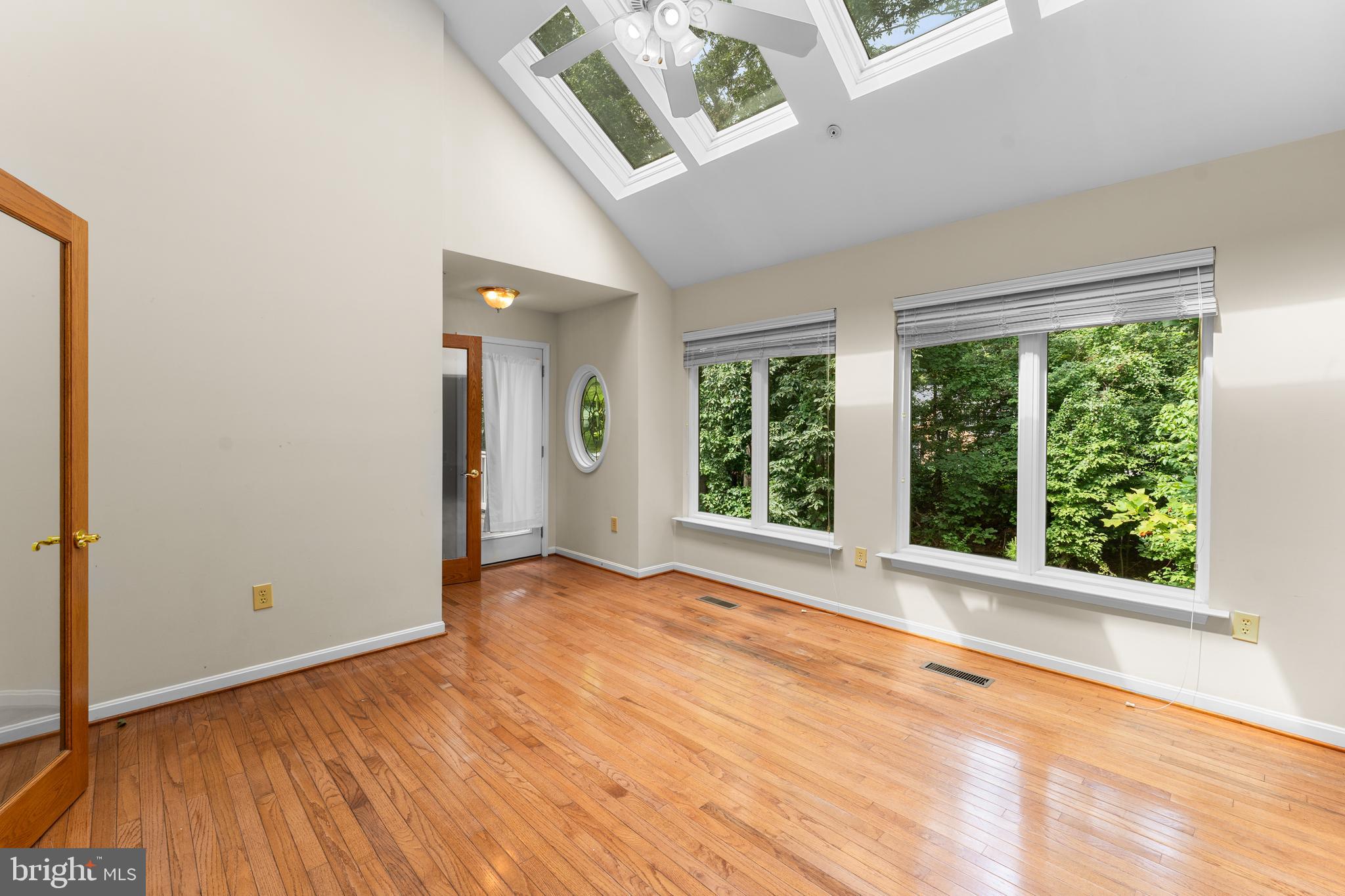 11709 Thrift Road Clinton, MD 20735 - Photo 12 of 71 an empty room with wooden floor and windows