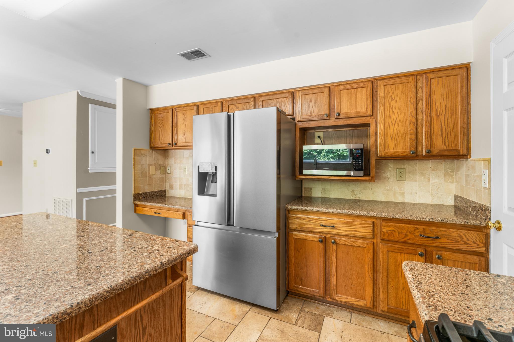11709 Thrift Road Clinton, MD 20735 - Photo 20 of 71 a kitchen with stainless steel appliances granite countertop a refrigerator a stove and a sink with granite countertops