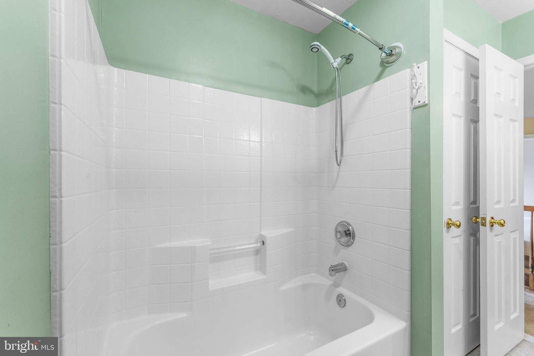 11709 Thrift Road Clinton, MD 20735 - Photo 56 of 71 a bathroom with a bathtub and a shower