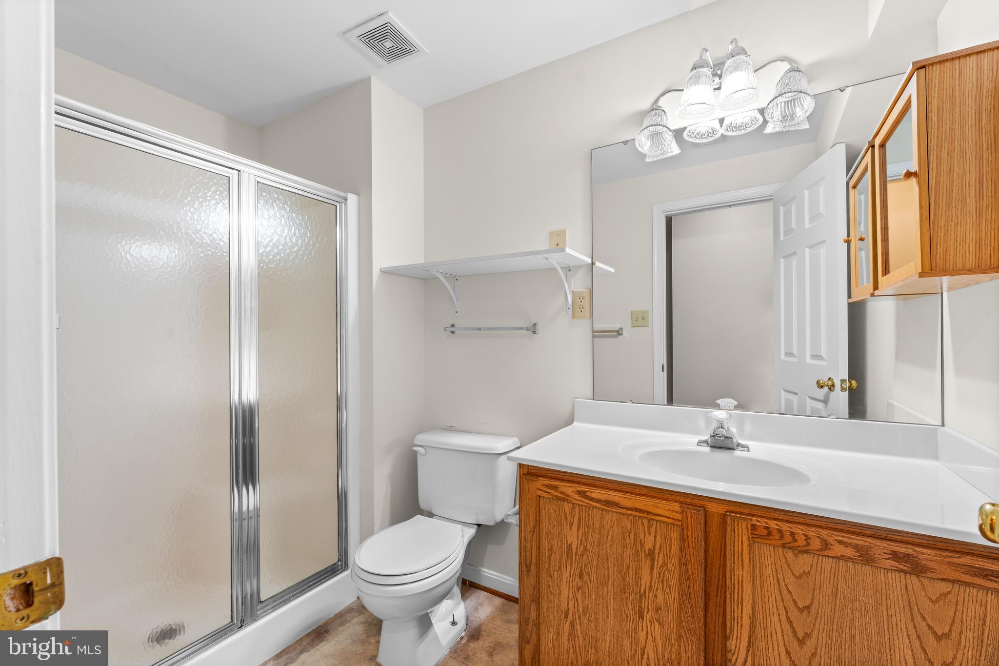 11709 Thrift Road Clinton, MD 20735 - Photo 65 of 71 a bathroom with a sink a toilet and a large mirror
