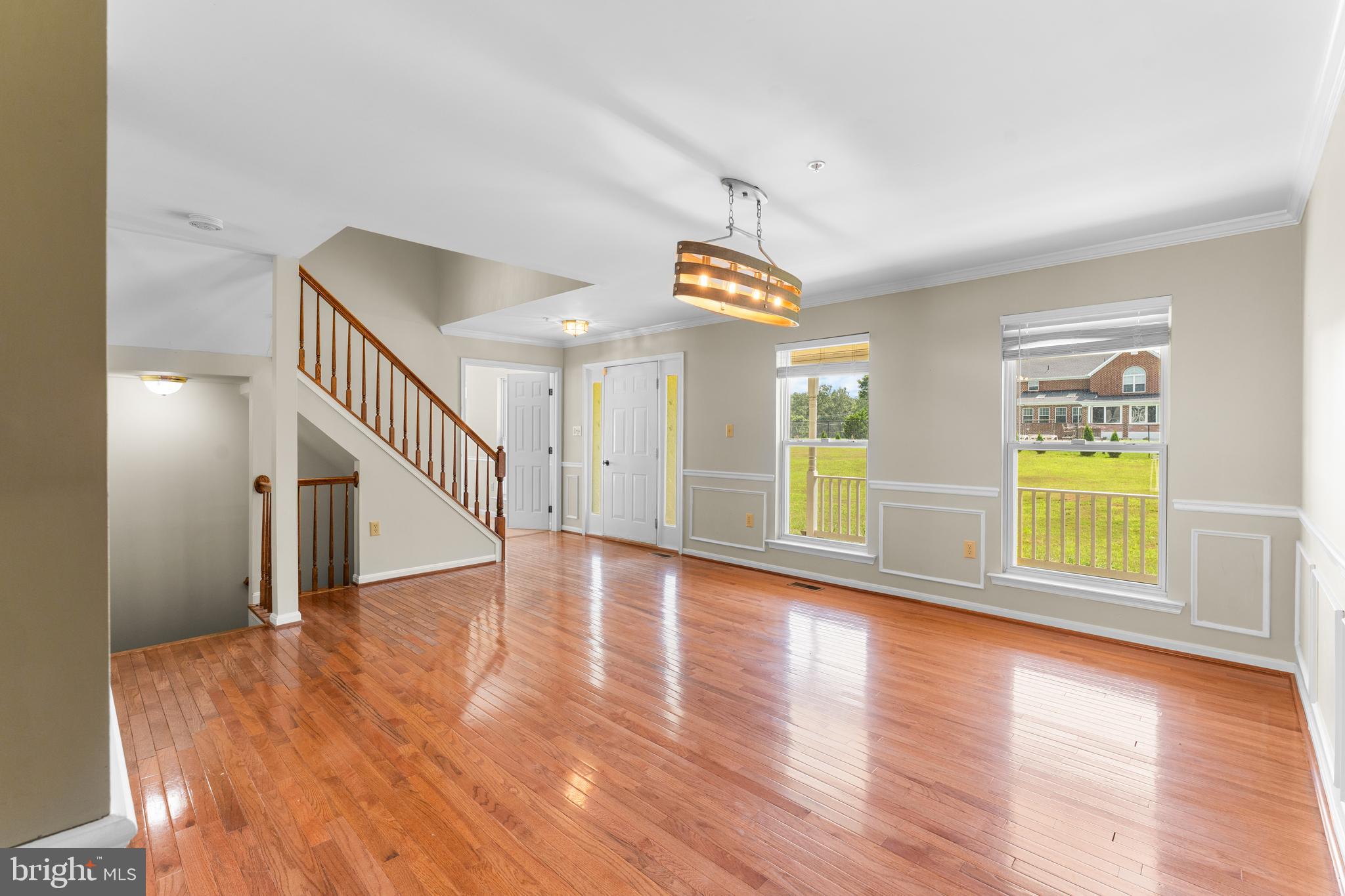 11709 Thrift Road Clinton, MD 20735 - Photo 10 of 71 a view of an empty room with wooden floor and a window
