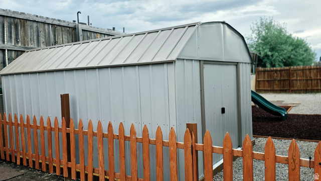 401 West 2000th Street South Vernal, UT 84078 - Photo 22 of 26 Metal storage shed with a gambrel roof and single entry door