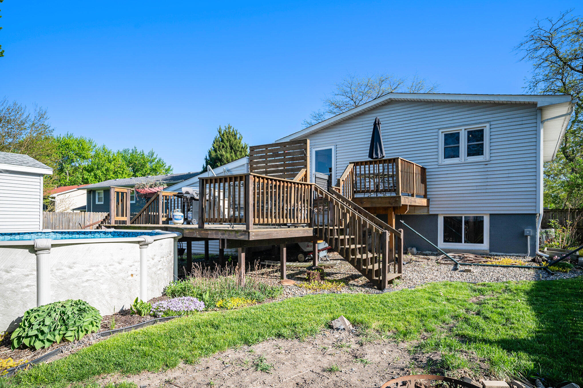 938 Walnut Lane Crown Point, IN 46307 - Photo 14 of 17 a front view of a house with a garden and plants