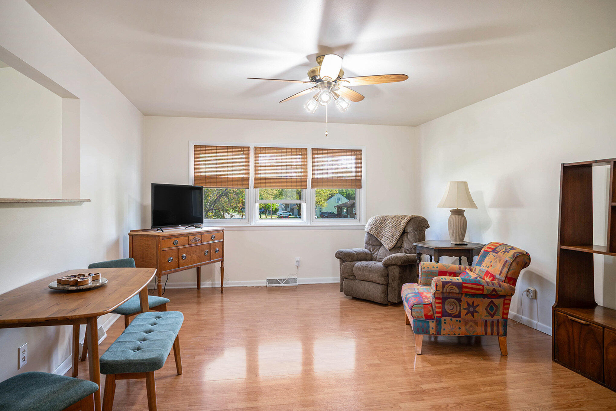 938 Walnut Lane Crown Point, IN 46307 - Photo 3 of 17 a living room with furniture a flat screen tv and a large window