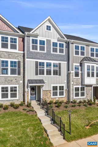 a front view of a residential apartment building with a yard