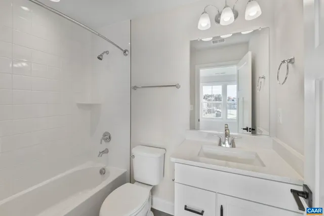 a large kitchen with stainless steel appliances granite countertop a refrigerator a sink dishwasher a oven and a large island with wooden floor