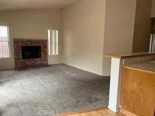 a view of an empty room with a fireplace