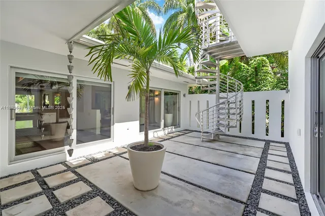 a view of a patio with table and chairs and potted plants