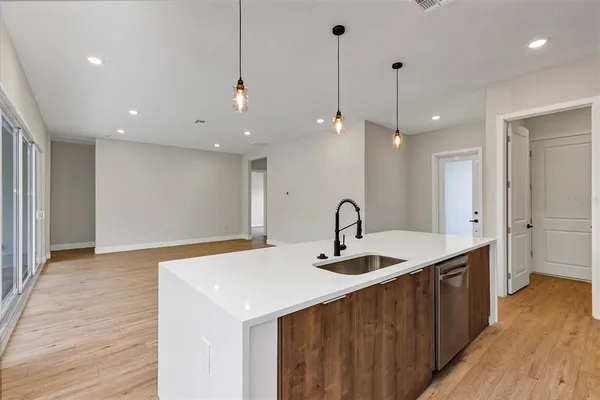 a kitchen with stainless steel appliances a stove microwave and sink