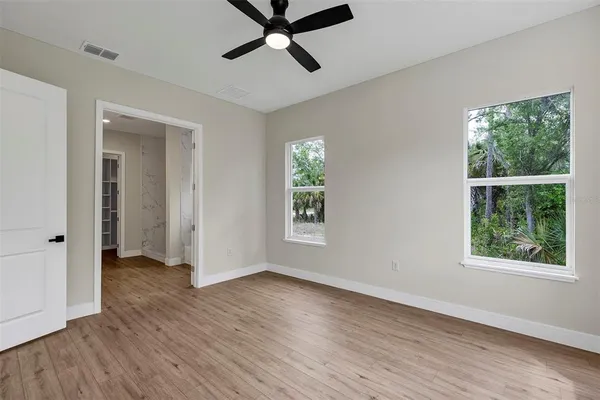 a view of a room with wooden floor and windows