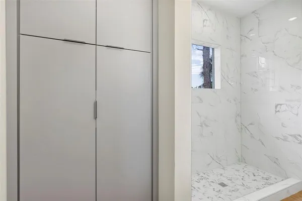 a bathroom with a toilet and a shower