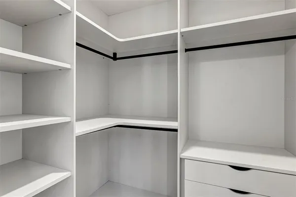 an empty room with wooden floor exposed radiator and windows