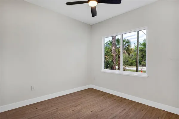 a view of an empty room with wooden floor