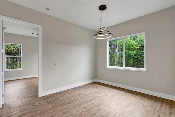 a view of a room with wooden floor staircase and windows