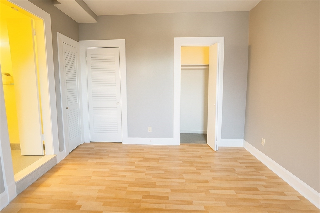 140 Chestnut Street, Unit 709 Springfield, MA 01103 - Photo 19 of 20 a view of empty room with wooden floor and windows