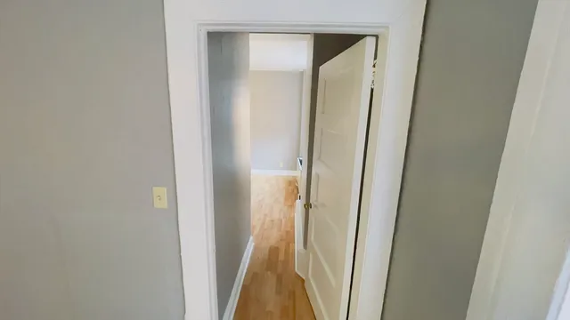 a view of a room with wooden floor