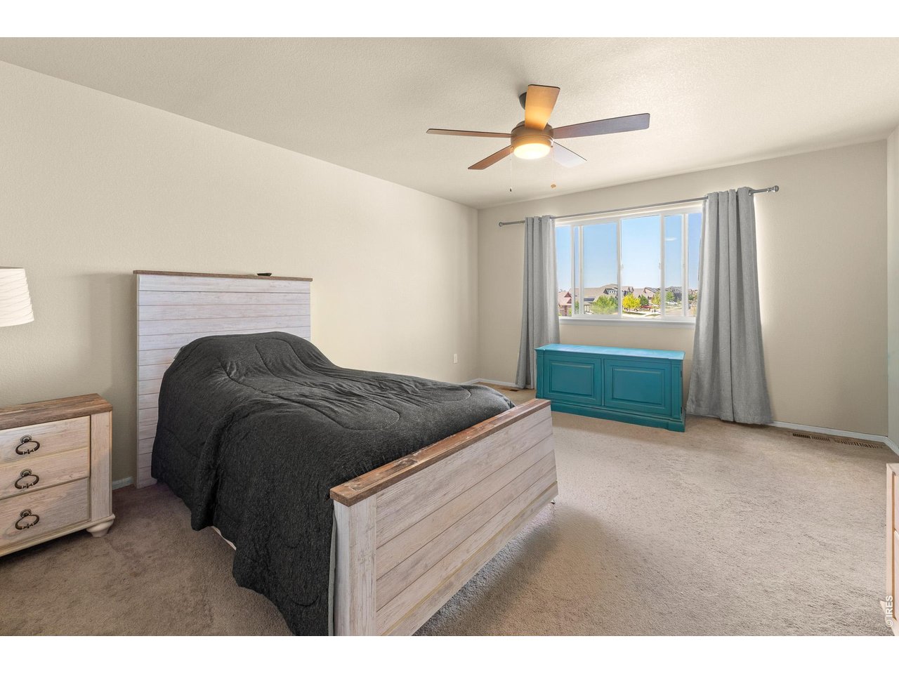 8847 16th St Road Greeley, CO 80634 - Photo 19 of 38 a bedroom with a bed and a ceiling fan